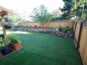 A section of "Artificial Turf" was incorporated beside the deck area at this project. Its primary function was to provide a "special spot" for the family pet to do its business. Artificial Turf will not discolour like real grass and you can control the door with the utilization of special (infill) products such as "ZeoFill"